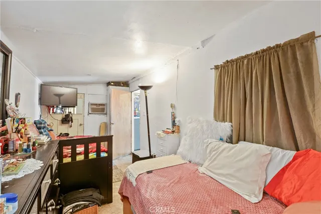 a bedroom with a bed and flat screen tv