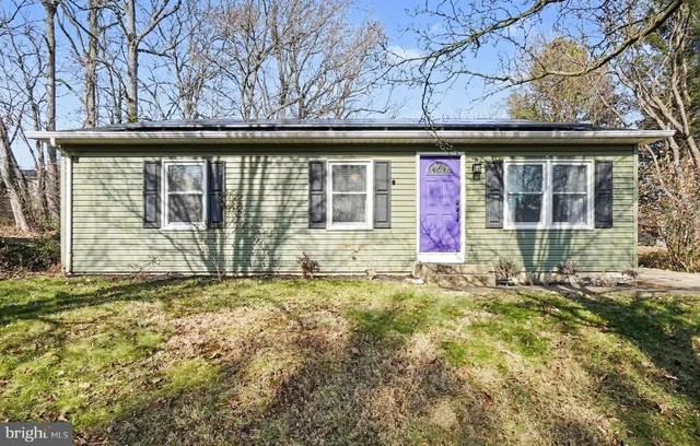a view of a house with a large window and brick walls