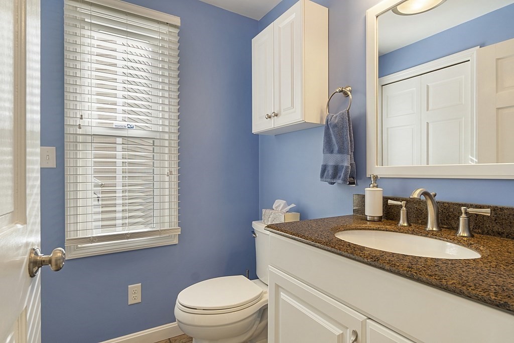 1541 Middlesex Street, Unit 16 Lowell, MA 01851 - Photo 15 of 29 a bathroom with a granite countertop sink and a toilet