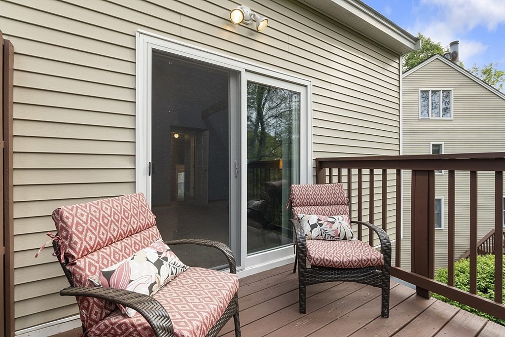 1541 Middlesex Street, Unit 16 Lowell, MA 01851 - Photo 23 of 29 a balcony with a couch and chairs