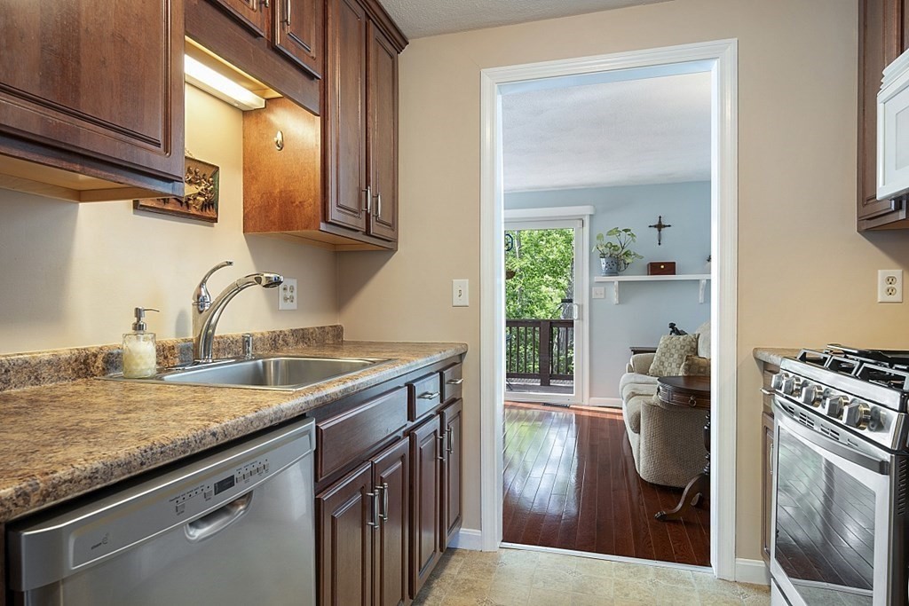 1541 Middlesex Street, Unit 16 Lowell, MA 01851 - Photo 7 of 29 a kitchen with a sink stove and cabinets