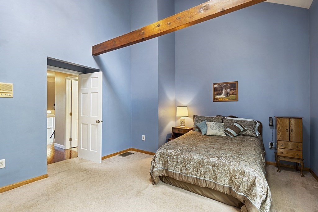 1541 Middlesex Street, Unit 16 Lowell, MA 01851 - Photo 10 of 29 a bedroom with a bed and a lamp