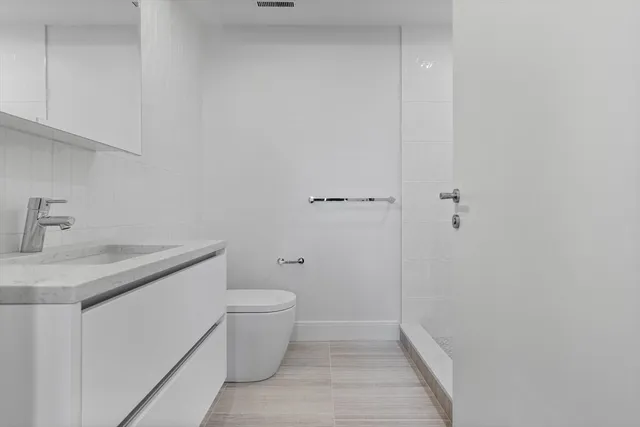 a bathroom with a sink toilet and vanity
