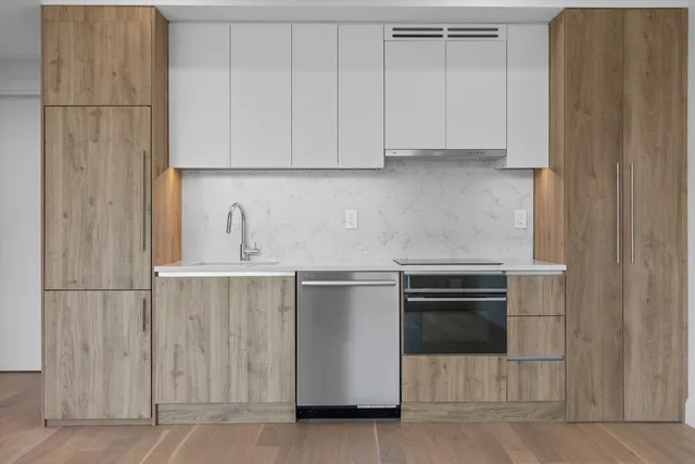 a kitchen with stainless steel appliances granite countertop a refrigerator and a stove