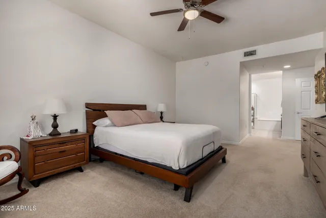 a spacious bedroom with a bed and a window