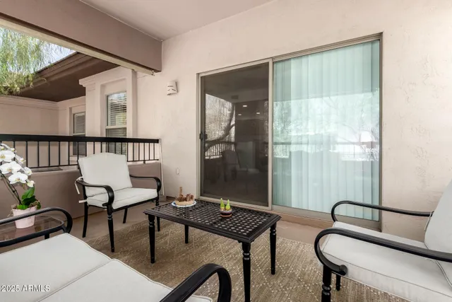 a living room with furniture and floor to ceiling windows