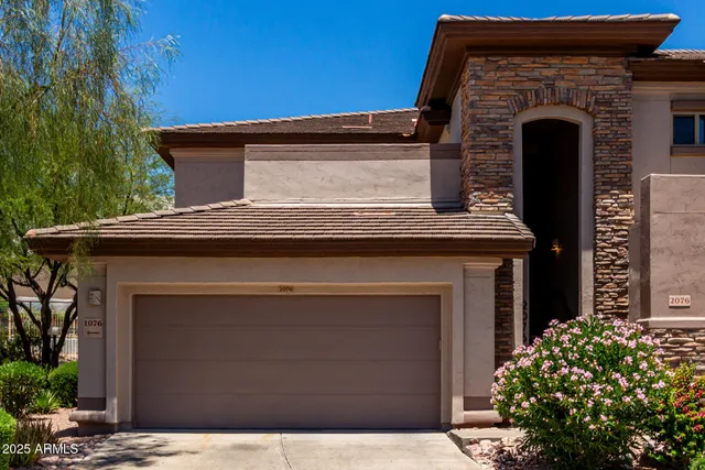 a front view of a house with plants