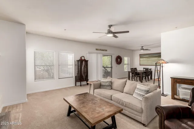 a dining room with furniture and a kitchen view