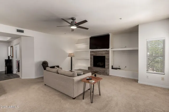 a living room with furniture and a fireplace