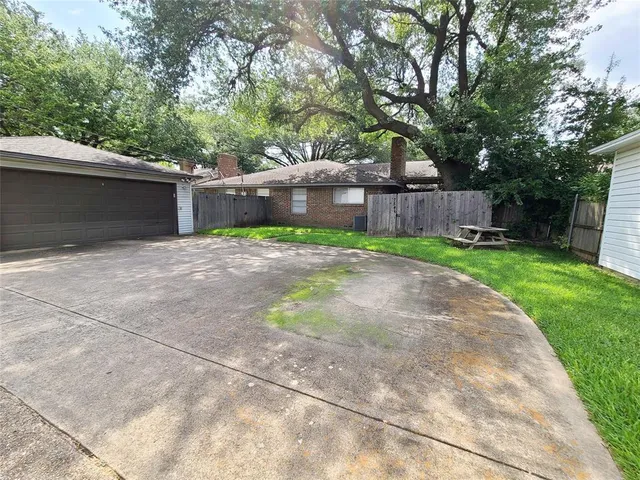 a backyard of a house with table and chairs