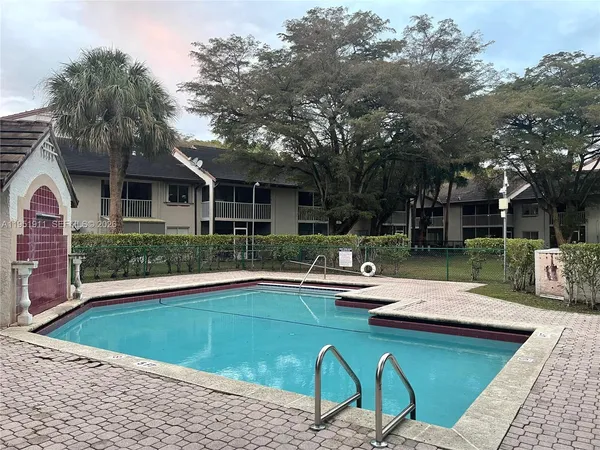 a swimming pool with outdoor seating and yard