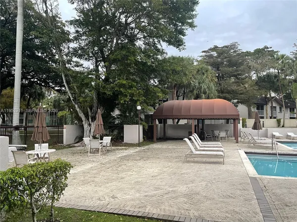 a view of a house with pool and sitting area