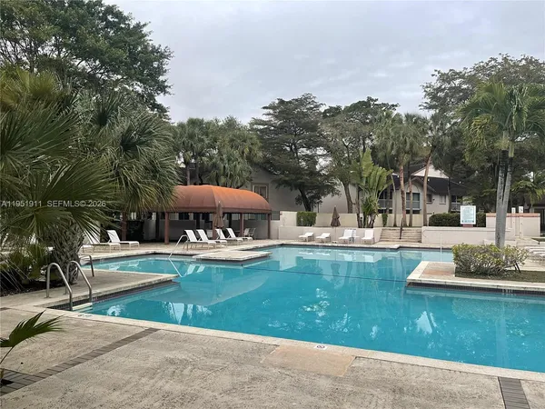 a view of a house with swimming pool and sitting area