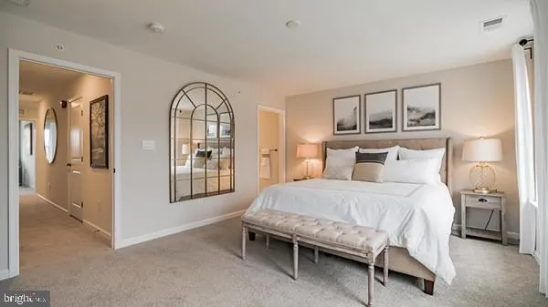a bedroom with a bed window and mirror