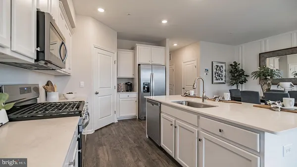 a kitchen with a sink stove and refrigerator