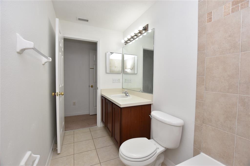 5410 River Rock Road Lakeland, FL 33809 - Photo 16 of 26 a white toilet sitting next to a bathroom sink