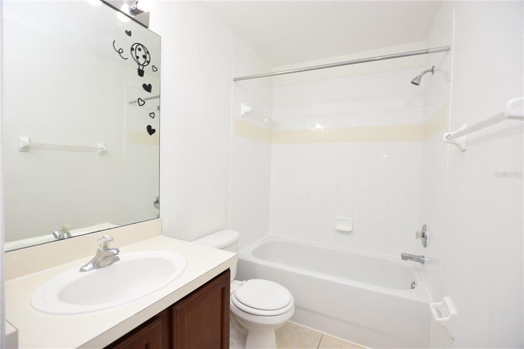 5410 River Rock Road Lakeland, FL 33809 - Photo 19 of 26 a bathroom with a bathtub shower sink vanity and toilet