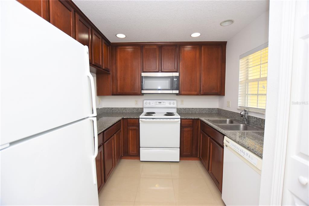 5410 River Rock Road Lakeland, FL 33809 - Photo 2 of 26 a kitchen with a stove top oven sink and cabinets