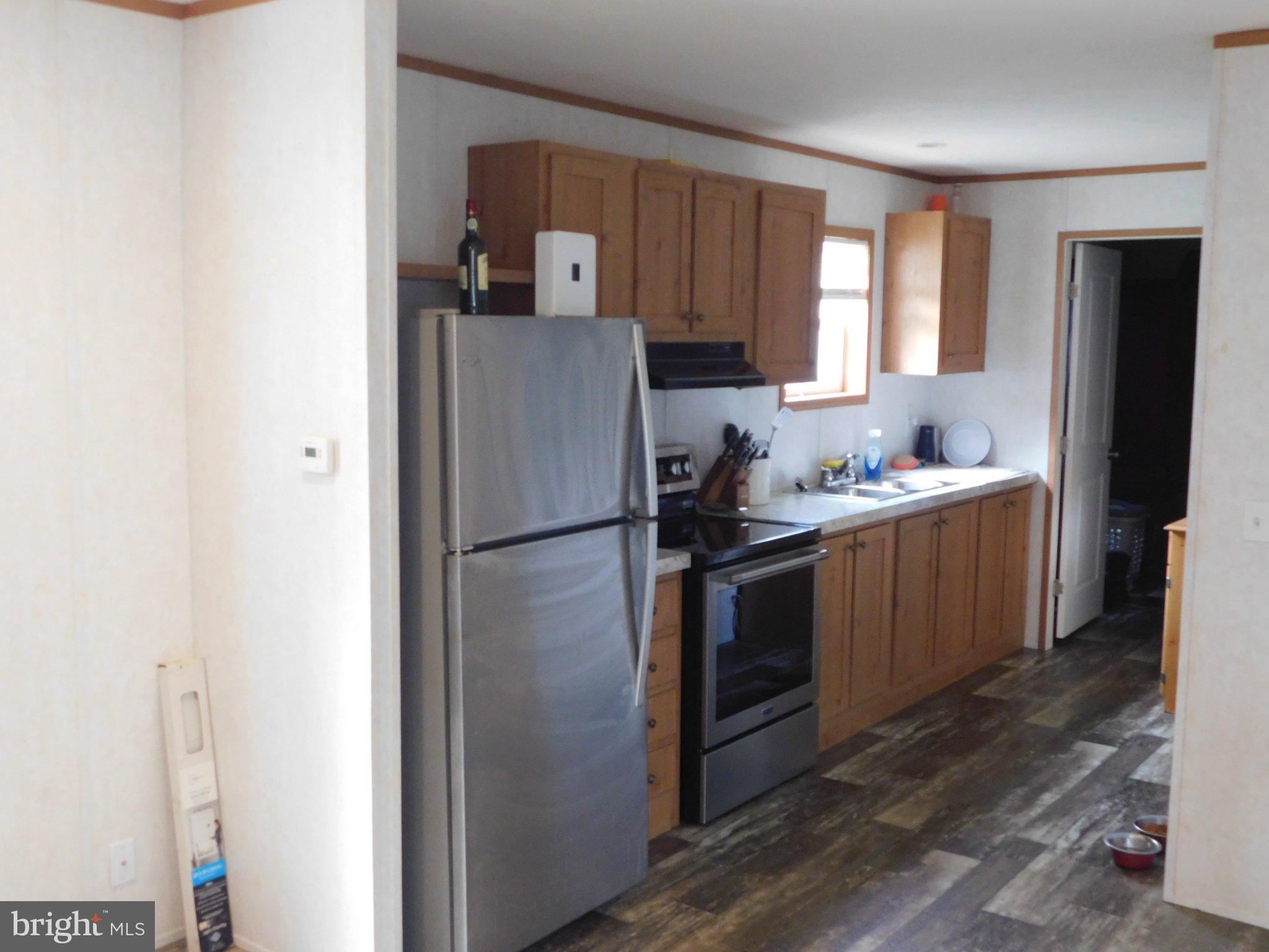 119 Meadow Lane Lititz, PA 17543 - Photo 3 of 13 a kitchen with a refrigerator sink and cabinets