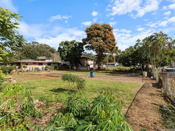 a view of yard with swimming pool and green space