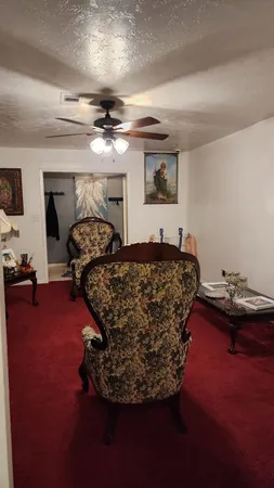 a bed room with furniture window and a ceiling fan