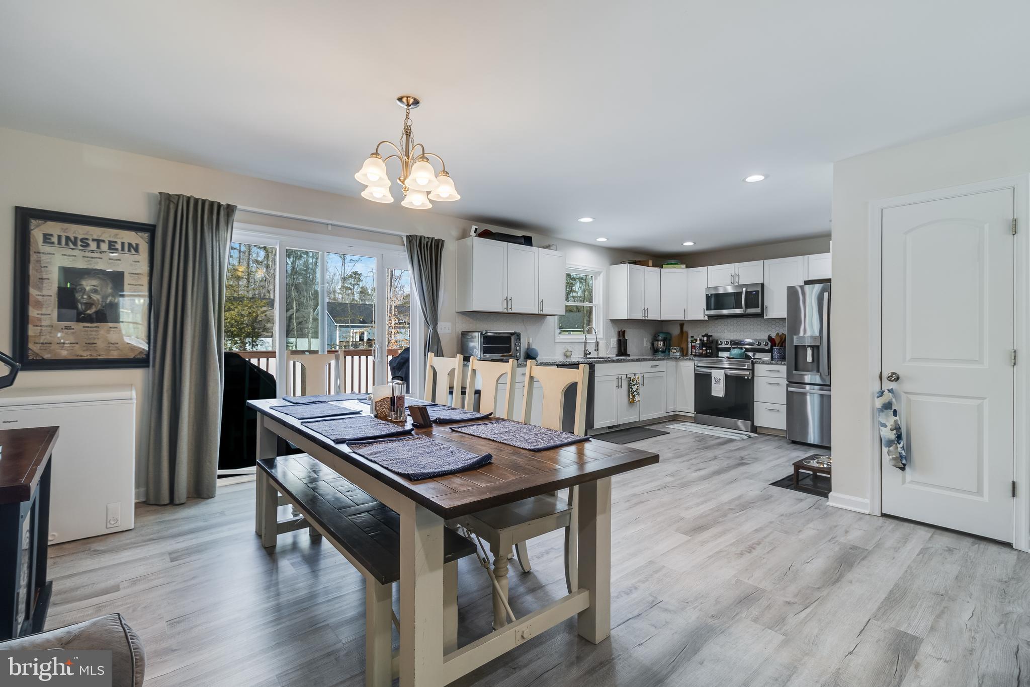 339 Azure Drive Colonial Beach, VA 22443 - Photo 12 of 28 a view of a dining room with furniture window and wooden floor