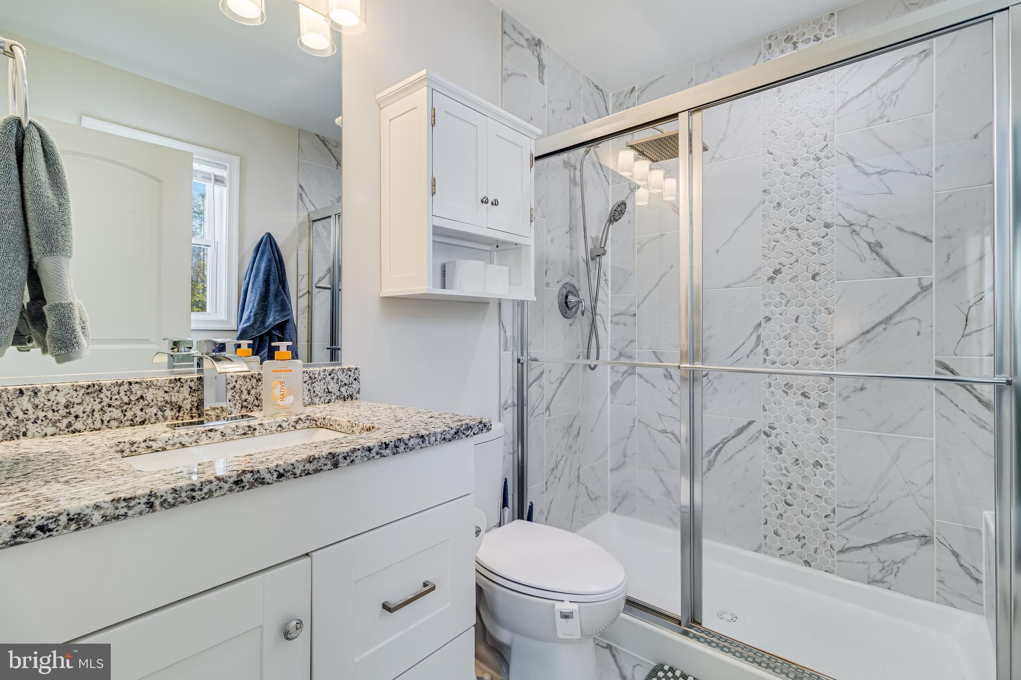 339 Azure Drive Colonial Beach, VA 22443 - Photo 17 of 28 a bathroom with a granite countertop sink toilet and shower