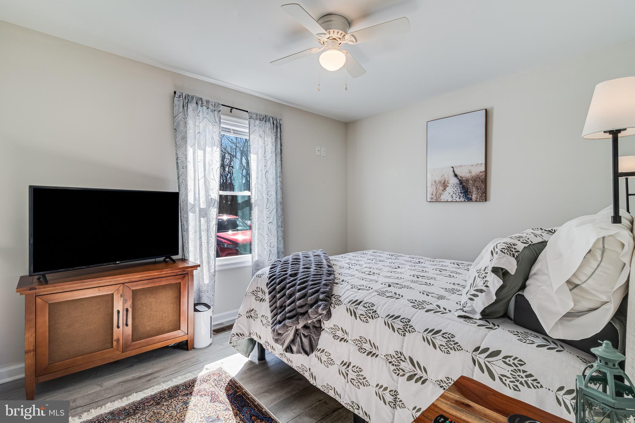 339 Azure Drive Colonial Beach, VA 22443 - Photo 19 of 28 a bedroom with a bed and flat screen tv