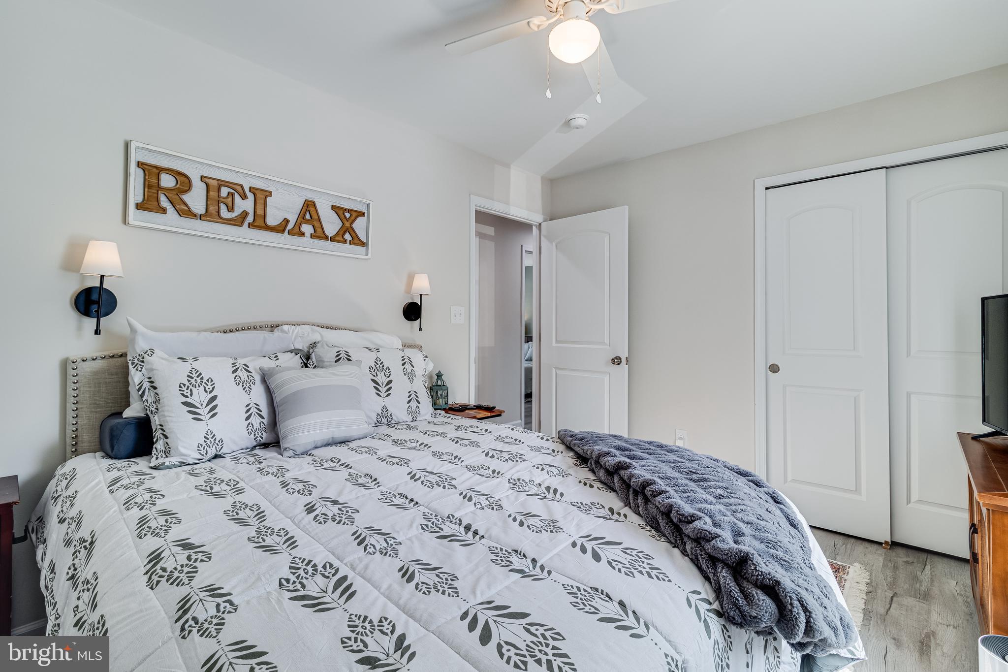 339 Azure Drive Colonial Beach, VA 22443 - Photo 20 of 28 a bedroom with a bed and a painting on the wall