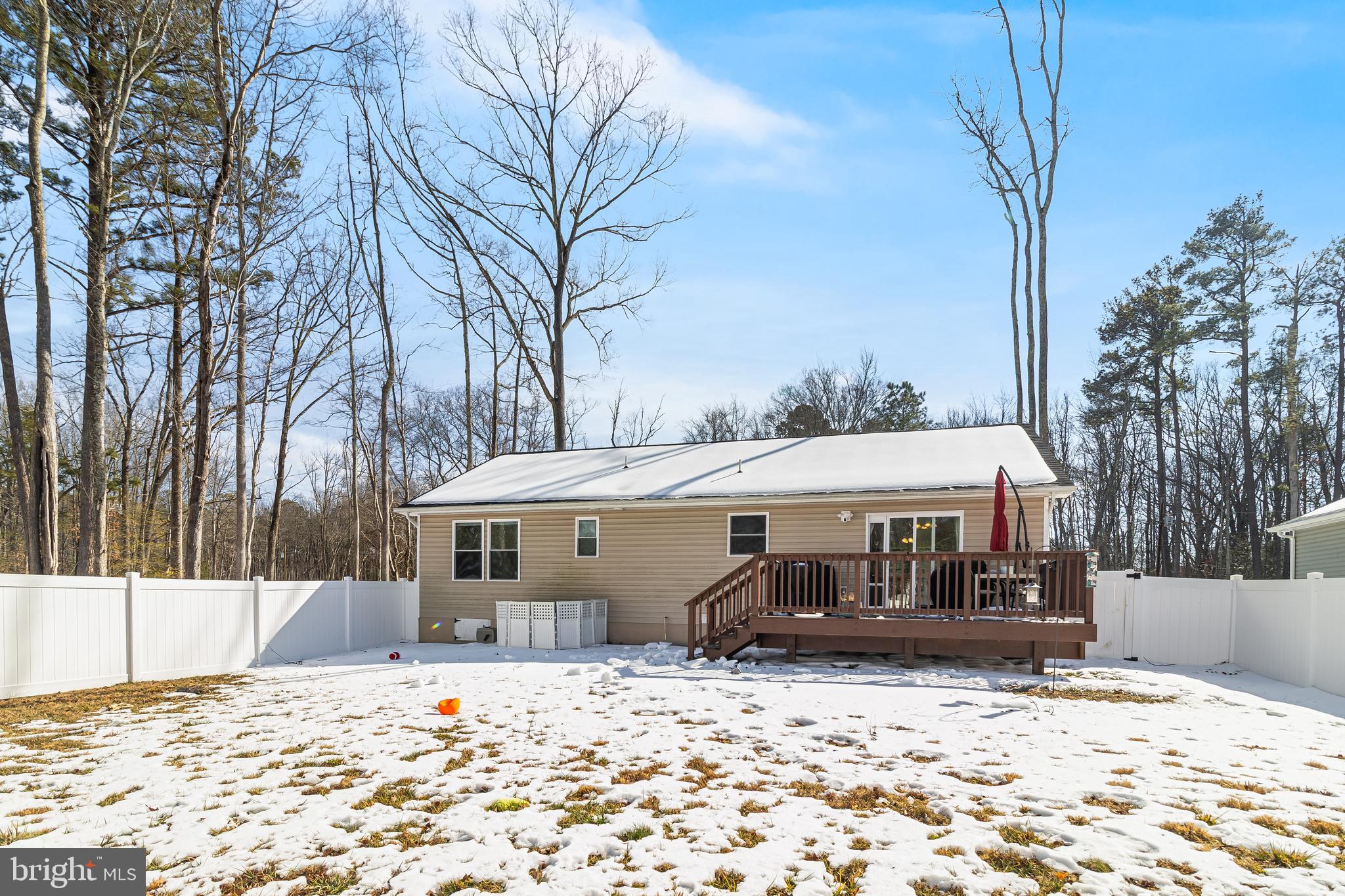 339 Azure Drive Colonial Beach, VA 22443 - Photo 27 of 28 a view of a house with a yard covered in snow