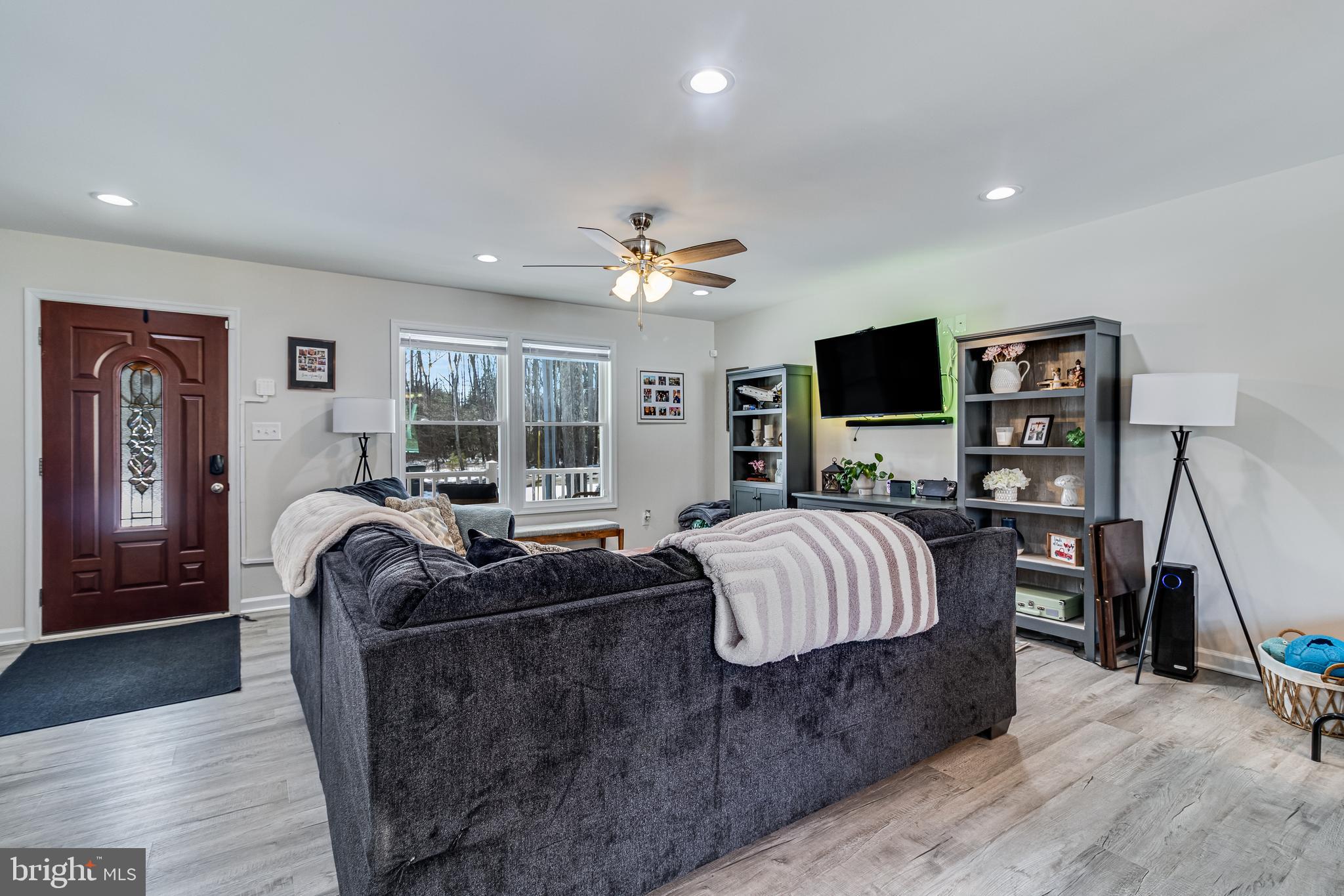 339 Azure Drive Colonial Beach, VA 22443 - Photo 7 of 28 a living room with furniture and a flat screen tv