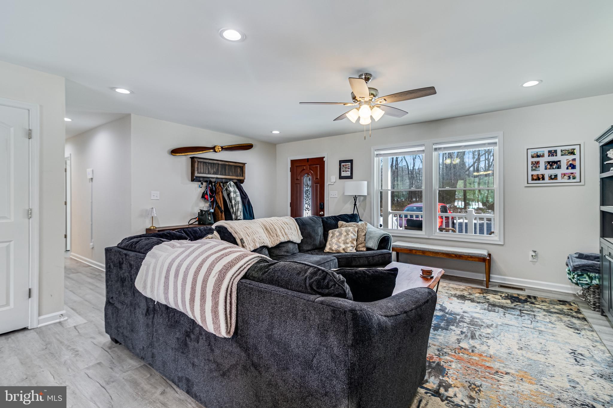 339 Azure Drive Colonial Beach, VA 22443 - Photo 8 of 28 a living room with furniture and a chandelier