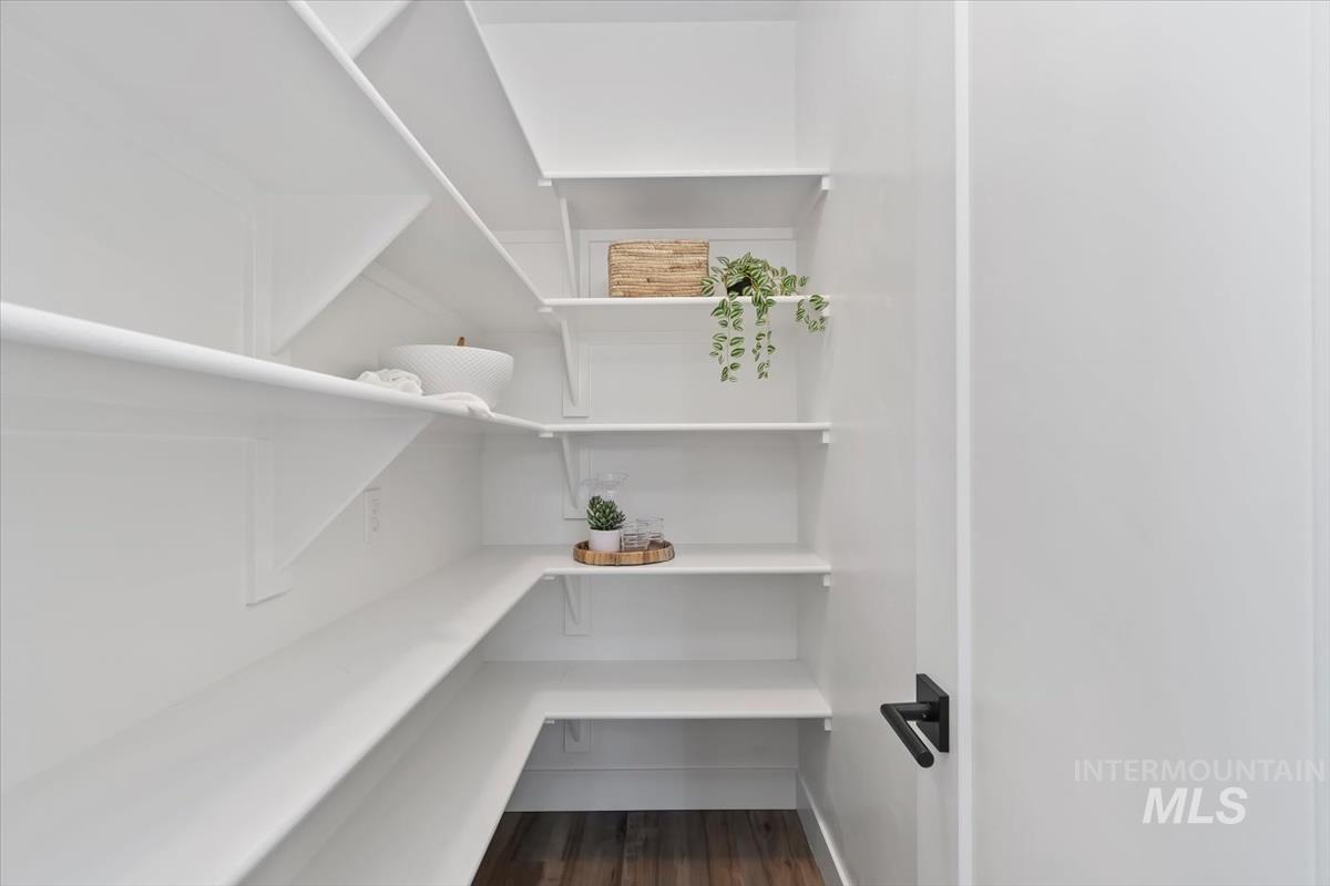 5897 West Riva Capri Street Meridian, ID 83646 - Photo 32 of 50 White built-in shelving with wood-finish flooring and a black hardware door