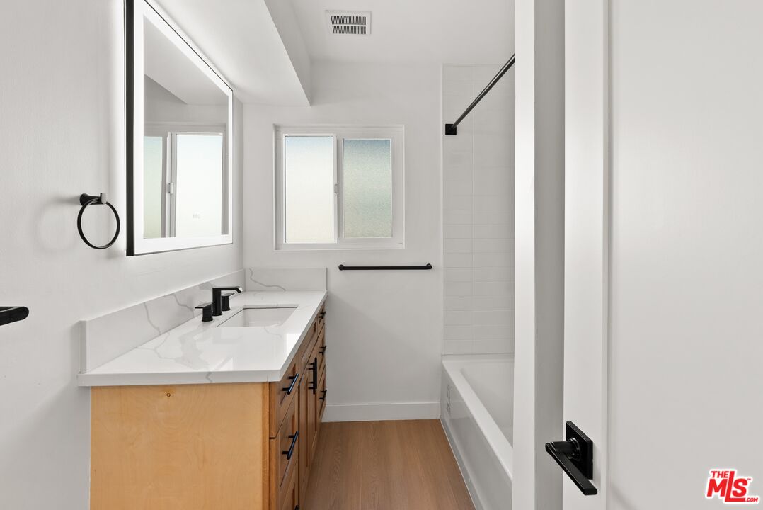 4020 La Salle Avenue Culver City, CA 90232 - Photo 20 of 33 a bathroom with a granite countertop sink and a mirror