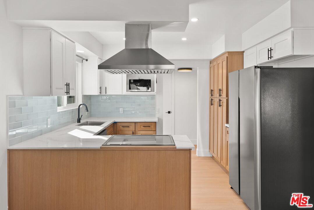 4020 La Salle Avenue Culver City, CA 90232 - Photo 7 of 33 a kitchen with stainless steel appliances granite countertop a refrigerator a sink and a stove