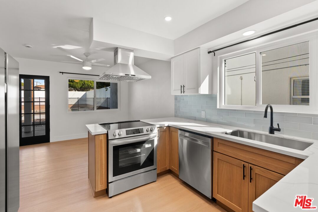 4020 La Salle Avenue Culver City, CA 90232 - Photo 10 of 33 a kitchen with a sink stove and cabinets