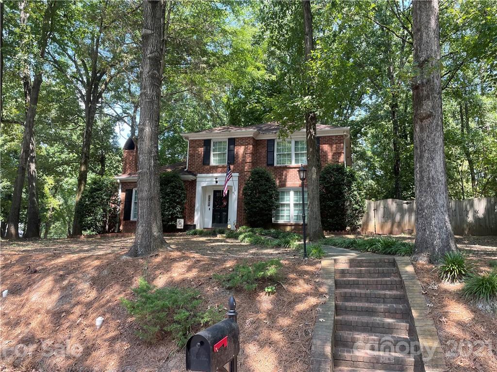9101 Sardis Forest Drive Charlotte, NC 28270 - Photo 2 of 5 a front view of a house with a yard