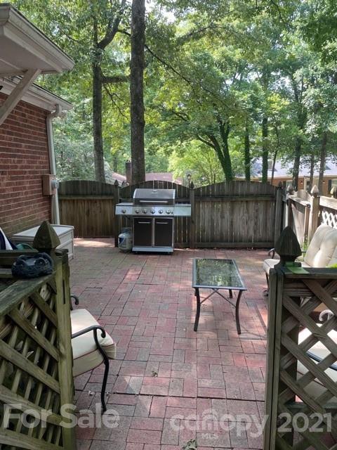 9101 Sardis Forest Drive Charlotte, NC 28270 - Photo 4 of 5 a view of a chairs and tables in the backyard