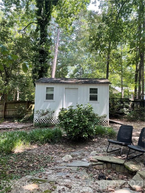 9101 Sardis Forest Drive Charlotte, NC 28270 - Photo 5 of 5 a view of a backyard with plants and a tree