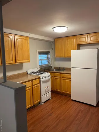 a kitchen with a refrigerator and a sink
