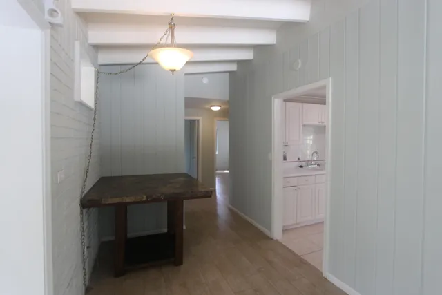 a room that has a mirror and a wooden floor