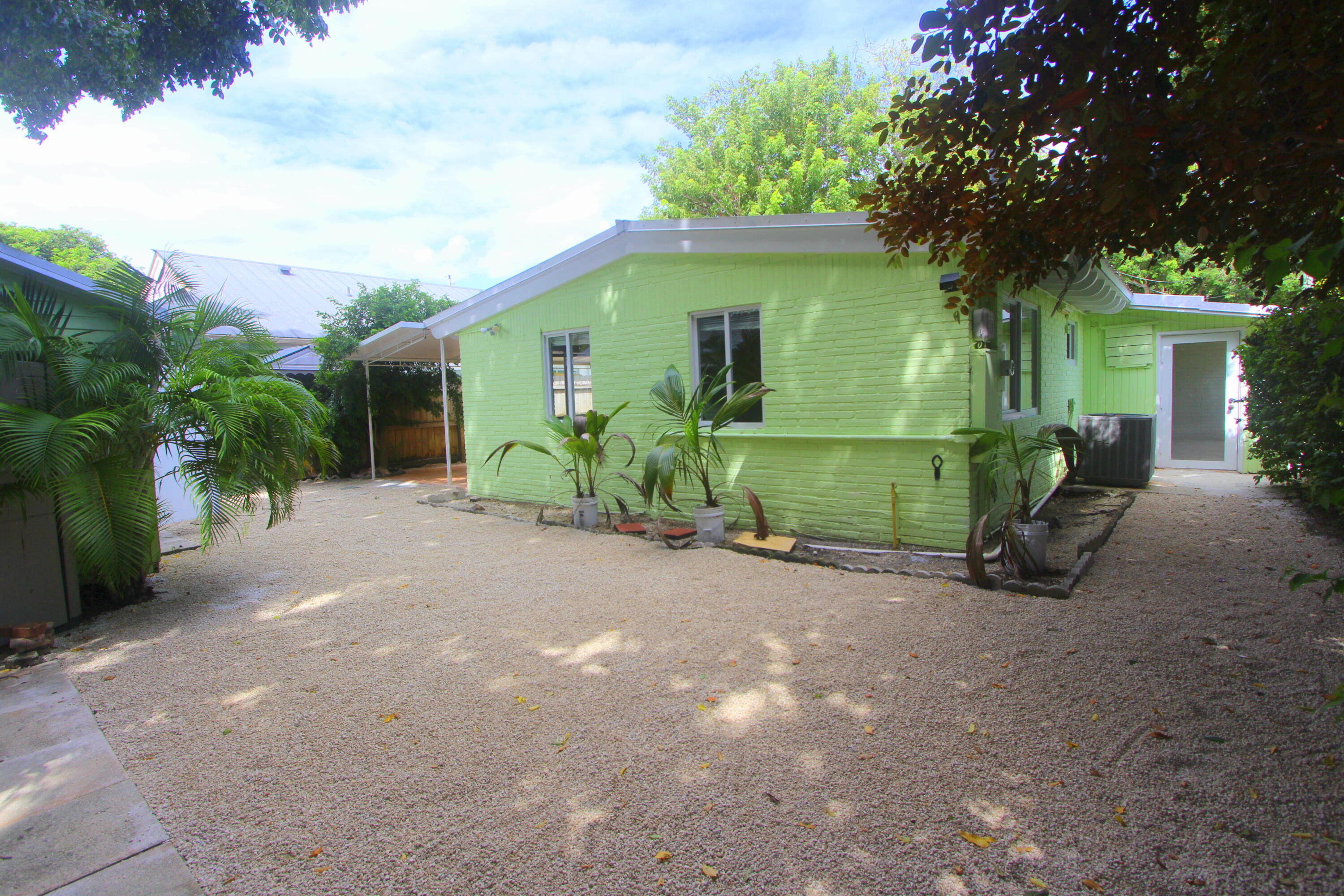 39 Bass Avenue Key Largo, FL 33037 - Photo 21 of 22 a front view of a house with garden