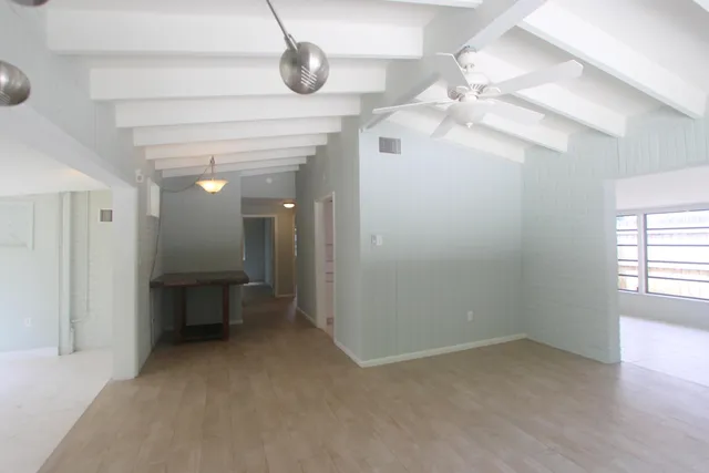 en empty room with fan and windows