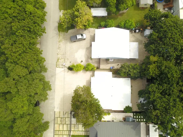 an aerial view of a house with a yard and lake view