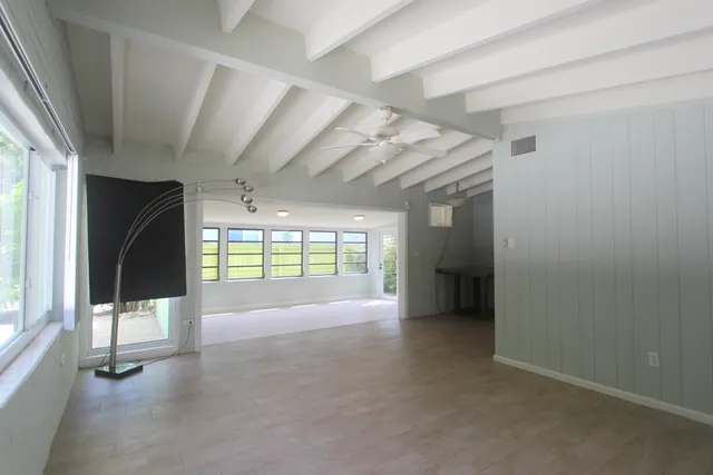 a view of an empty room with a sliding door and a window