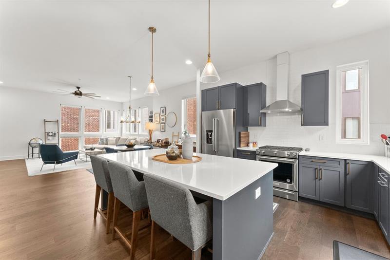 1256 Chelsea Circle Northwest Atlanta, GA 30318 - Photo 13 of 52 a kitchen with stainless steel appliances kitchen island granite countertop a sink a stove a dining table and chairs