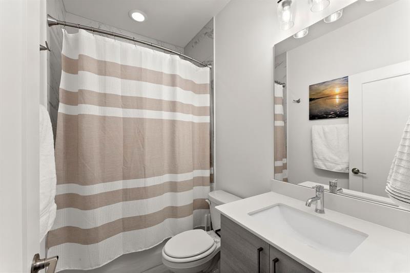 1256 Chelsea Circle Northwest Atlanta, GA 30318 - Photo 29 of 52 a bathroom with a sink a toilet a shower and a mirror