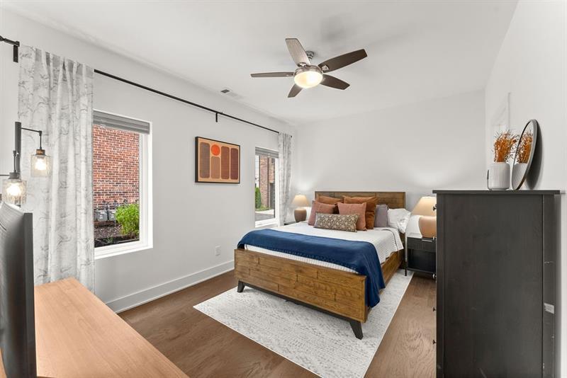 1256 Chelsea Circle Northwest Atlanta, GA 30318 - Photo 6 of 52 a bedroom with a bed and wooden floor