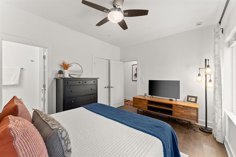 1256 Chelsea Circle Northwest Atlanta, GA 30318 - Photo 7 of 52 a bedroom with a bed and a flat screen tv