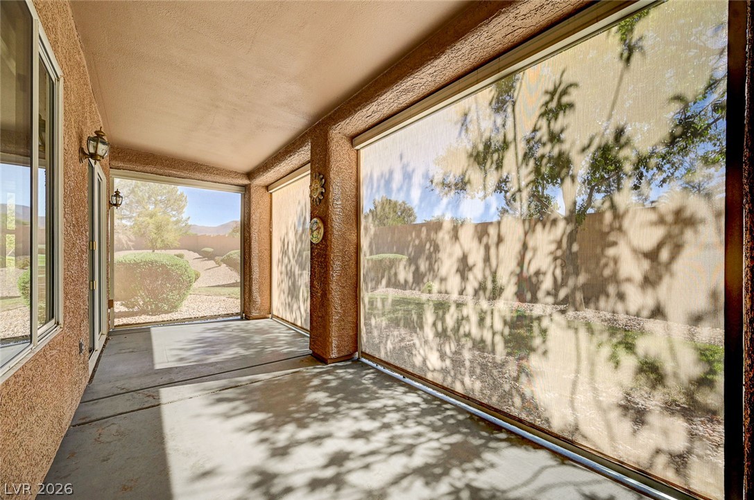 2529 Springville Way Henderson, NV 89052 - Photo 49 of 70 Retractable screens shade a concrete covered patio overlooking the backyard.